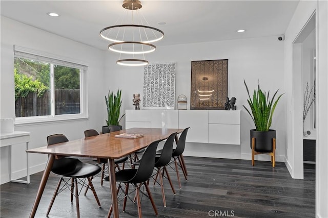 dining area with baseboards, dark wood-type flooring, and recessed lighting