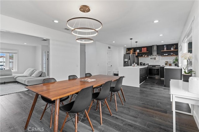 dining room with dark wood-style floors, visible vents, and recessed lighting