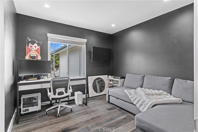 bedroom with wood finished floors and recessed lighting