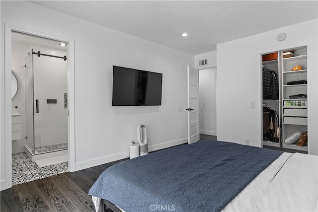 bedroom featuring baseboards, visible vents, wood finished floors, a spacious closet, and recessed lighting