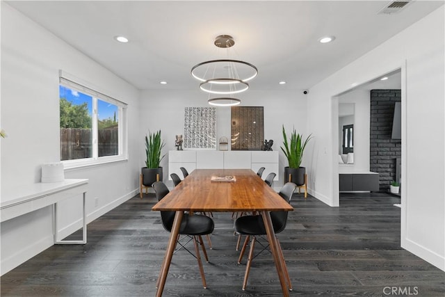 dining room featuring dark wood-style floors, visible vents, and recessed lighting