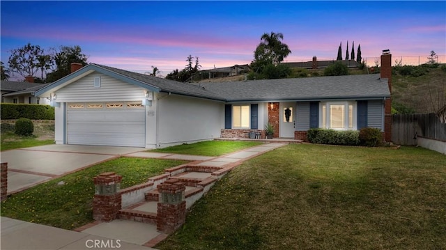 ranch-style house with brick siding, concrete driveway, a lawn, an attached garage, and fence