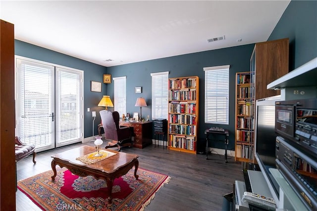 home office with visible vents, baseboards, wood finished floors, and french doors