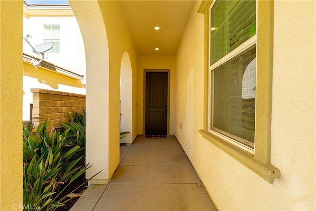 view of exterior entry with stucco siding