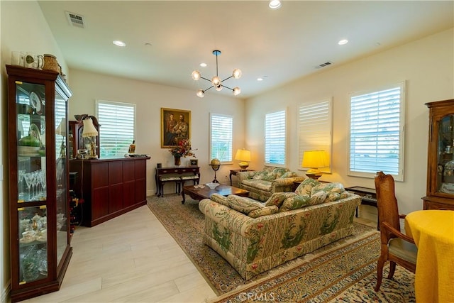 living room with a chandelier, light wood-style floors, visible vents, and recessed lighting