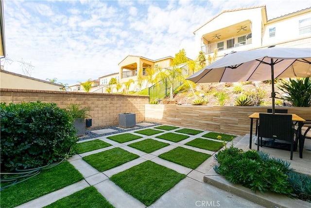 view of yard featuring ceiling fan, a patio, central AC unit, and fence