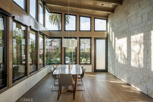 sunroom / solarium featuring beam ceiling and wood ceiling