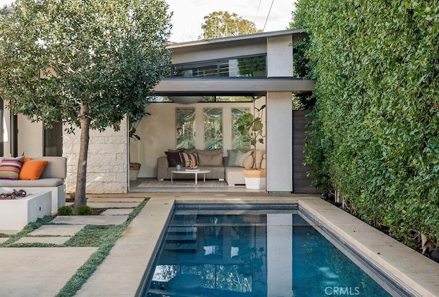 view of swimming pool with a patio area and an outdoor living space