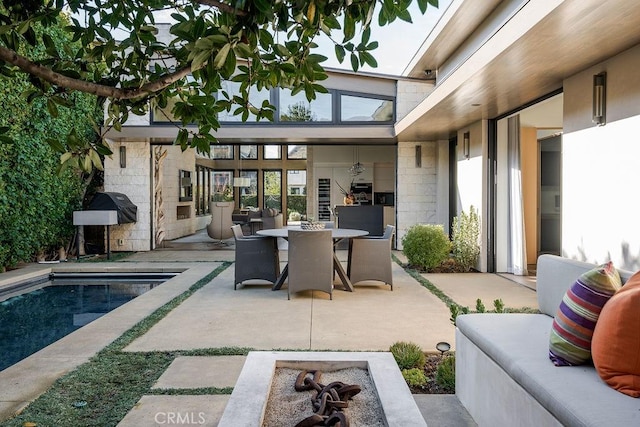 view of patio / terrace featuring outdoor dining area and an outdoor pool