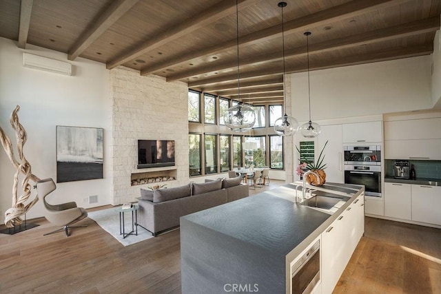 kitchen featuring dark countertops, appliances with stainless steel finishes, white cabinets, a sink, and modern cabinets