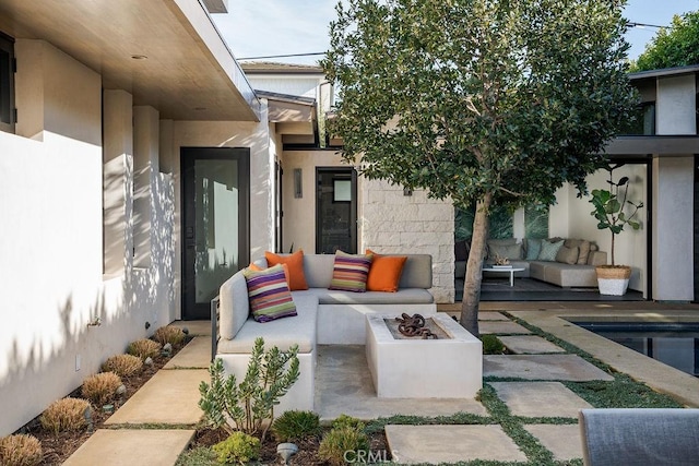 view of patio featuring an outdoor living space with a fire pit