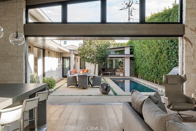 pool with outdoor lounge area and a patio