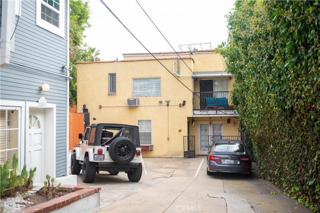 1204 N Clark St, West Hollywood, CA 90069 - exterior space featuring stucco siding and a wall mounted AC