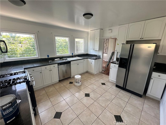 1204 N Clark St, West Hollywood, CA 90069 - kitchen featuring white cabinets, stainless steel appliances, a sink, dark countertops, and light tile patterned floors