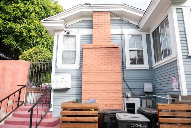 1204 N Clark St, West Hollywood, CA 90069 - view of home's exterior featuring brick siding, fence, and a gate