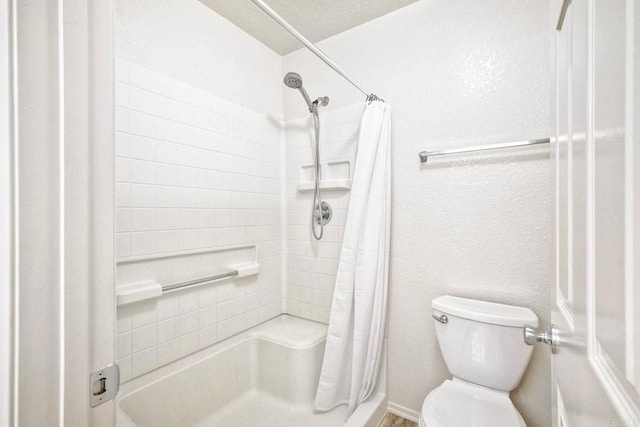 bathroom with curtained shower and toilet