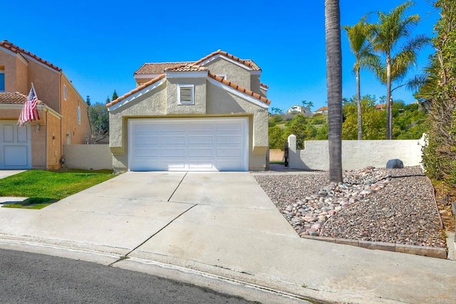 view of front of home featuring driveway, a tiled roof, an attached garage, fence, and stucco siding