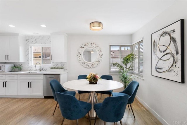 dining room with light wood-style flooring, recessed lighting, and baseboards