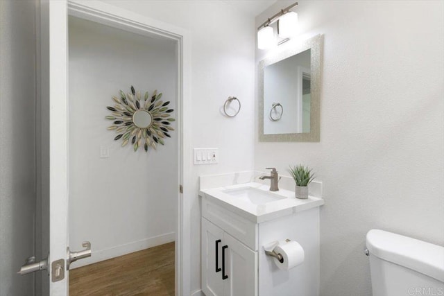 3735 Budd St, San Diego, CA 92111 - bathroom featuring baseboards, wood finished floors, toilet, and vanity