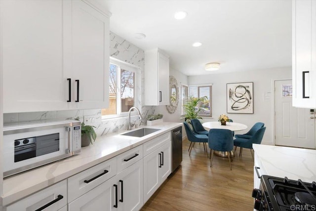 3735 Budd St, San Diego, CA 92111 - kitchen featuring white cabinets, light wood-style floors, a sink, and stainless steel appliances