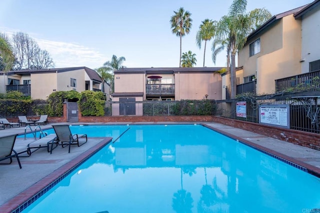 pool featuring a patio area and fence