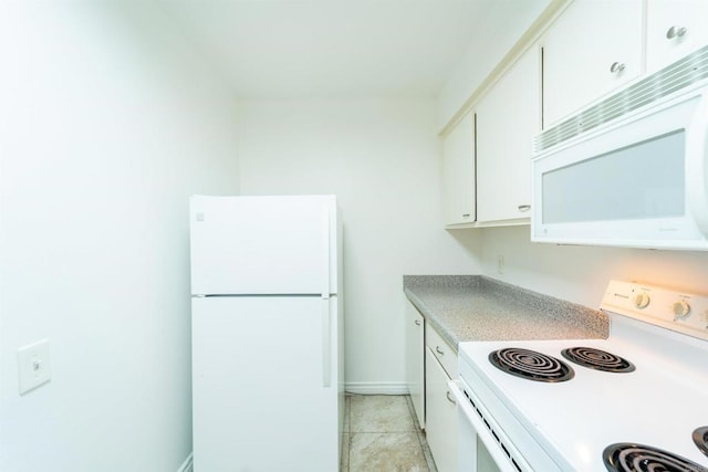 kitchen featuring light tile patterned flooring, white appliances, baseboards, white cabinets, and light countertops