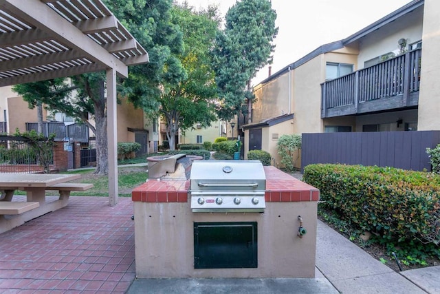 view of patio featuring fence, a pergola, and area for grilling