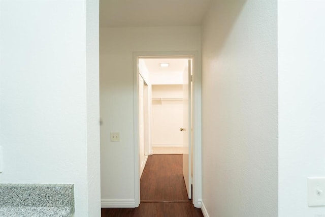 hallway with baseboards and dark wood finished floors