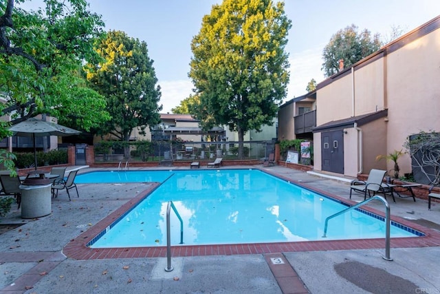 pool featuring a patio area and fence