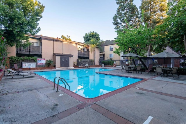 pool featuring a patio area and fence