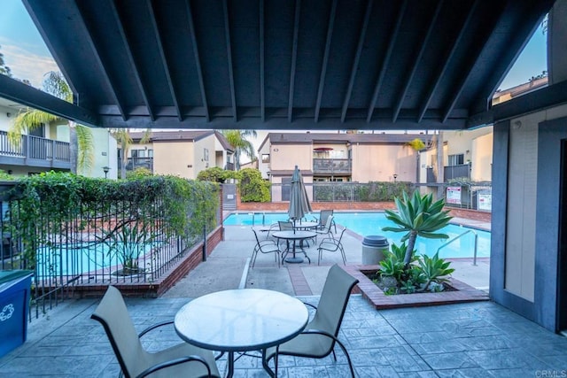 pool featuring a patio and fence