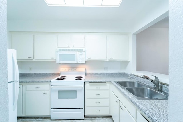 kitchen with light countertops, white appliances, a sink, and white cabinets