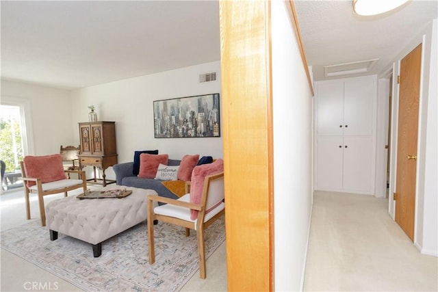 living area featuring attic access and visible vents