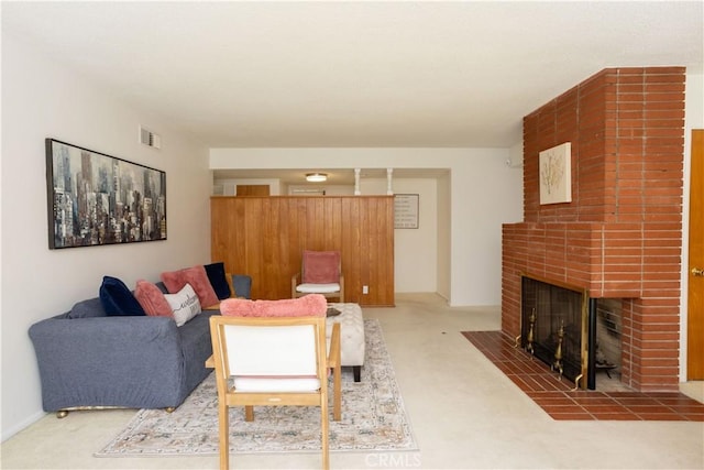 living area with carpet floors, a brick fireplace, and visible vents