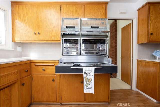 kitchen featuring brown cabinetry and decorative backsplash