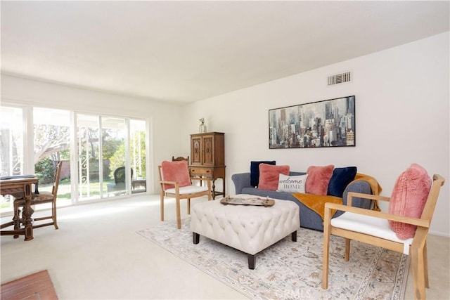 living room with visible vents and light colored carpet