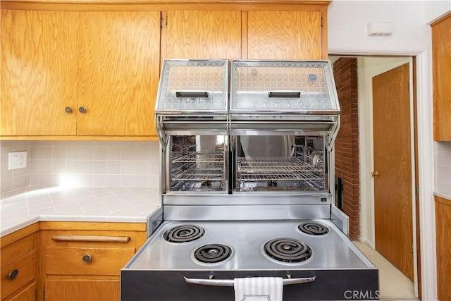 kitchen featuring tile countertops and decorative backsplash