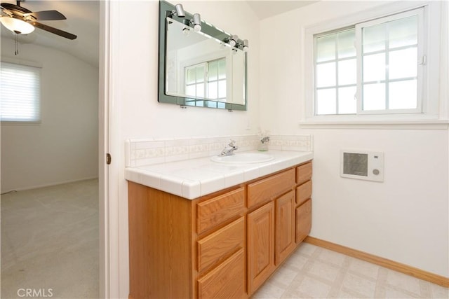 bathroom with tile patterned floors, baseboards, a ceiling fan, and vanity