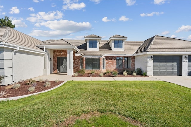 view of front facade with a garage, a tile roof, driveway, and a front lawn