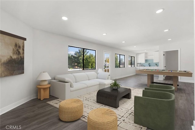 living room featuring baseboards, dark wood finished floors, and recessed lighting