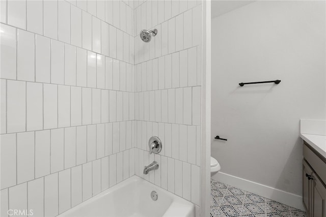 bathroom featuring toilet, vanity, shower / tub combination, tile patterned flooring, and baseboards