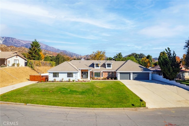 view of front facade with an attached garage, fence, a tiled roof, concrete driveway, and a front yard