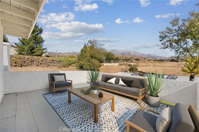 view of patio / terrace with outdoor lounge area and a mountain view