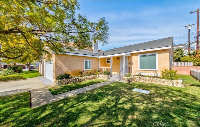 view of front facade with a front yard, fence, driveway, and stucco siding