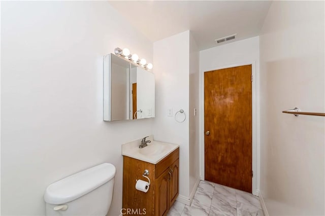 bathroom featuring marble finish floor, visible vents, toilet, vanity, and baseboards