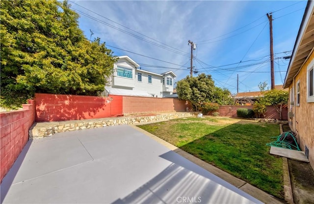 view of yard featuring a fenced backyard and a patio