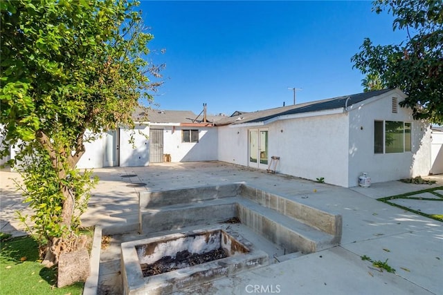 view of front of house featuring french doors, fence, a patio, and stucco siding