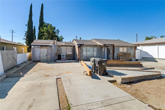 ranch-style house with fence and a patio