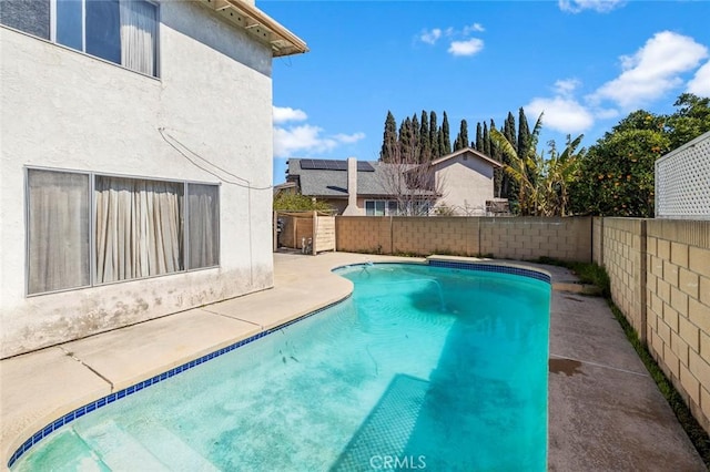 view of swimming pool featuring a patio, a fenced backyard, and a fenced in pool