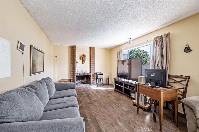 living room featuring a textured ceiling and wood finished floors